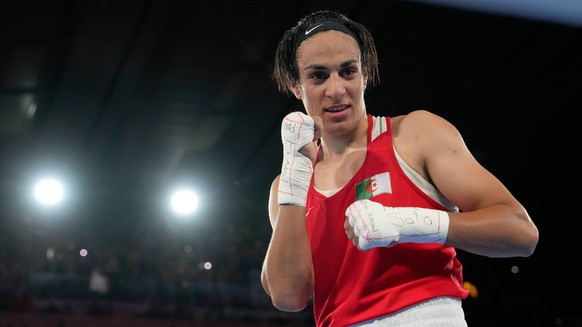 Algeria's Imane Khelif poses after defeating China's Yang Liu to win gold in their women's 66 kg final boxing match at the 2024 Summer Olympics, Friday, Aug. 9, 2024, in Paris, France.  ...