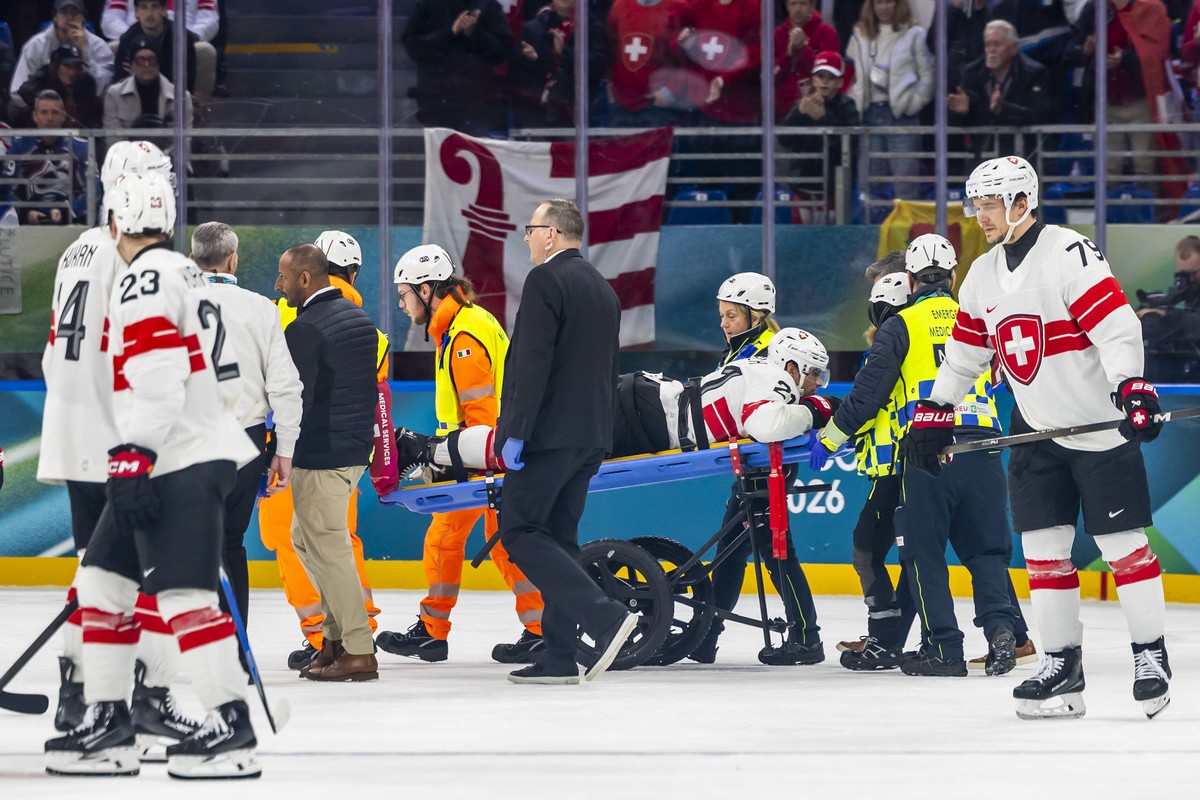 Injured Switzerland's Kevin Fiala #21, injured, is stretchered on a stretcher off the ice by paramedics, during the men's group A preliminary round game between Canada and Switzerland at the ...