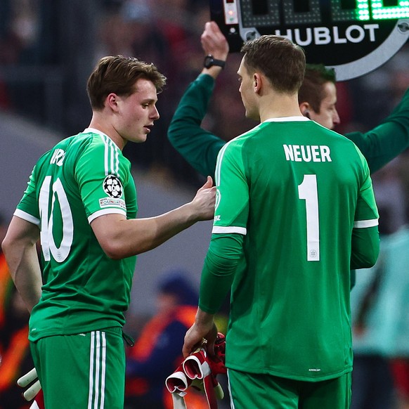 epa11943165 Goalkeeper Jonas Urbig (L) enters the pitch as he replaces Manuel Neuer of Bayern Munich (R) during the UEFA Champions League Round of 16, 1st leg soccer match between FC Bayern Munich and ...