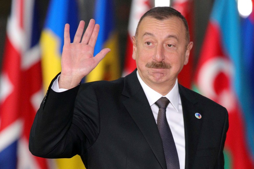 FILE- In this Friday, Nov. 24, 2017 file photo, Azerbaijan&#039;s President Ilham Aliyev waves as he arrives for an Eastern Partnership Summit in Brussels. Voters in the oil-rich Caspian Sea nation of ...
