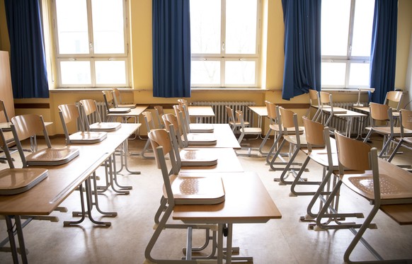 epa08291329 Chairs stand on the tables of an empty classroom at the Rupprecht-Gymnasium in Munich, Bavaria, Germany, 13 March 2020. In an effort to prevent the COVID-19 disease caused by the SARS-CoV- ...