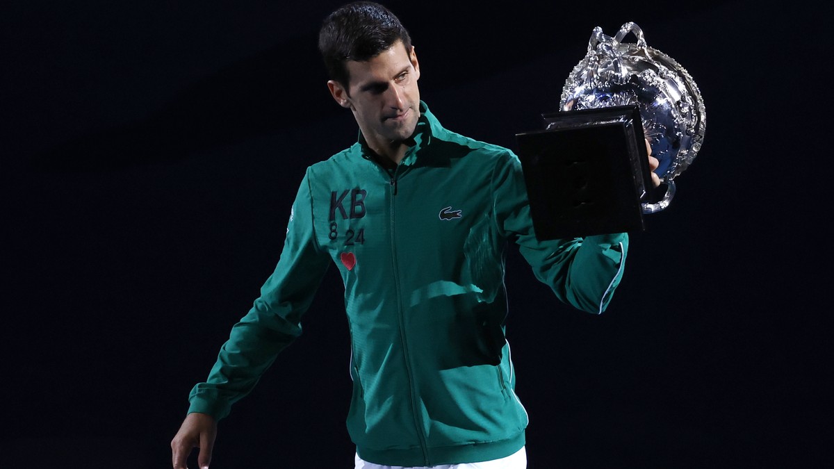 Serbia's Novak Djokovic carries the Norman Brookes Challenge Cup around Rod Laver Arena after defeating Austria's Dominic Thiem in the men's singles final of the Australian Open tennis  ...