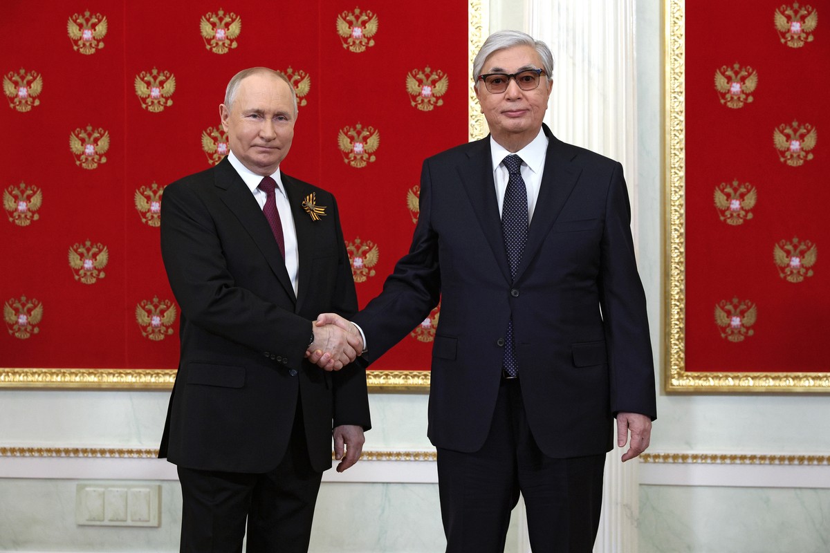 Russian President Vladimir Putin, left, and Kazakhstan's President Kassym-Jomart Tokayev shake hands at their meeting during the 78th anniversary of the end of World War II celebrations in Moscow ...