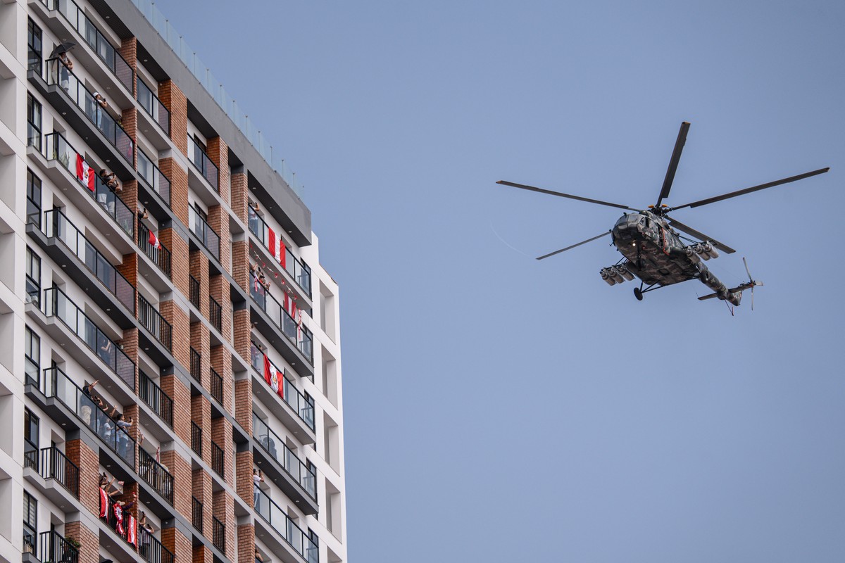 epa13140681 People watch a helicopter fly during the traditional civic-military parade commemorating the 205th anniversary of Peru's independence in Lima, Peru, 29 July 2026. Fujimori was sworn i ...