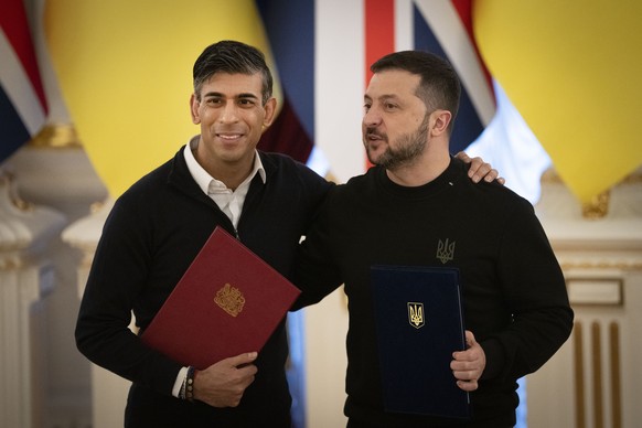 British Prime Minister Rishi Sunak, left, hugs Ukrainian President Volodymyr Zelenskyy after signing documents in Kiev, Ukraine, Friday, Jan. 12, 2024. (AP Photo/Efrem Lukatsky)