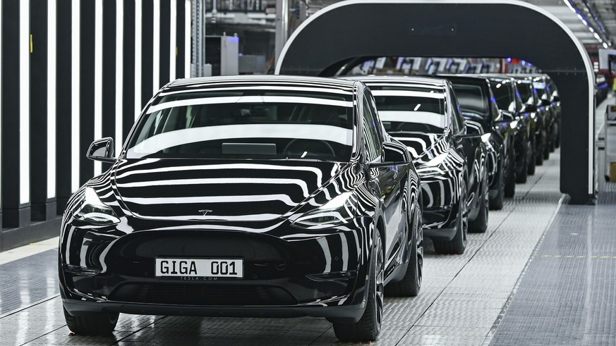 Model Y electric vehicles stand on a conveyor belt at the opening of the Tesla factory in Berlin Brandenburg in Gruenheide, Germany, Tuesday, March 22, 2022. The first European factory in Gruenheide,  ...