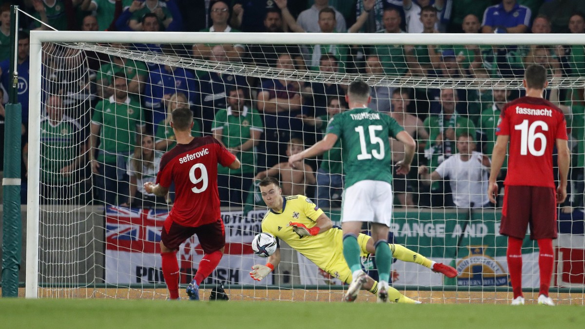 Northern Ireland's goalkeeper Bailey Peacock-Farrell, back, saves a penalty shot by Switzerland's Haris Seferovic, left, during the World Cup 2022 group C qualifying soccer match between Nor ...