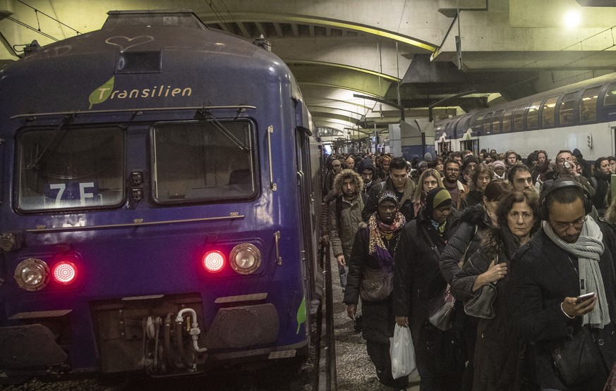 Commuters arrive at at Gare Montparnasse train station during the 29th day of transport strikes in Paris, Thursday, Jan. 2, 2020. The start of 2020 was the second New Year celebration in a row where M ...