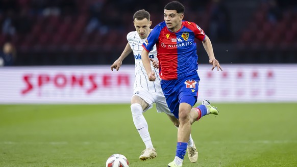 FC Zurich's Nikola Puranigasev, left, plays on the ball with FC Basel's Zaki Amdouni in the Premier League soccer championship match between FC Zurich and FC Basel, on Saturday, April 8-20...