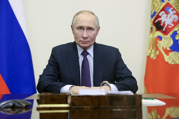 Russian President Vladimir Putin delivers a video address to congratulate employees and veterans of the Russian Prosecutor&#039;s Office on their professional holiday at the Novo-Ogaryovo state reside ...