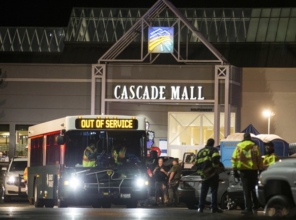 Emergency personnel stand in front of an entrance to the Cascade Mall at the scene of a shooting where several people were killed Friday, Sept. 23, 2016, in Burlington, Wash. Police searched Saturday  ...