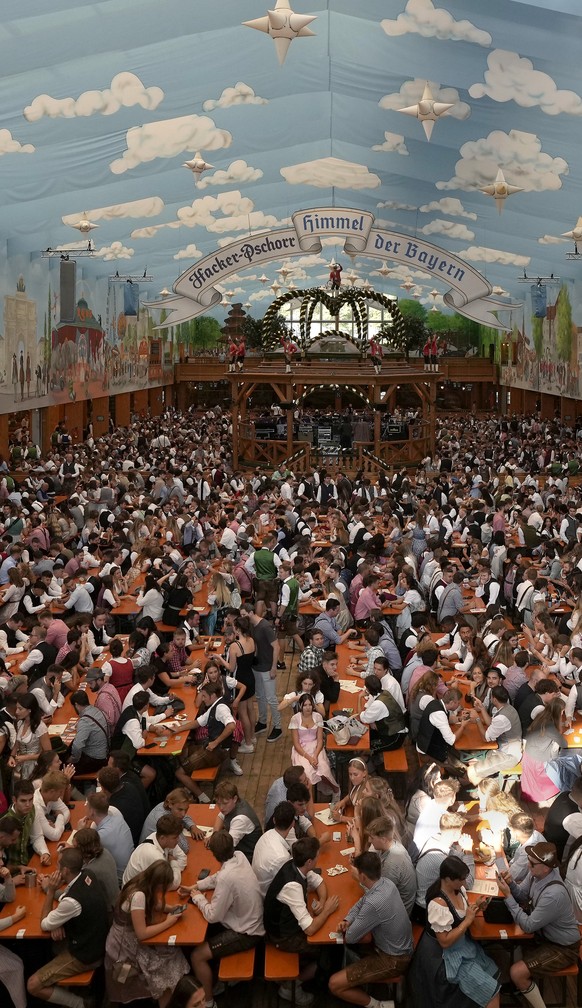 People sit in a marquee shortly after the opening of the 188th &#039;Oktoberfest&#039; beer festival in Munich, Germany, Saturday, Sept. 16, 2023. (AP Photo/Matthias Schrader)