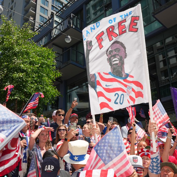 A United States fans holds up a sign for United States' Folarin Balogun (20) during the march to the match before the World Cup round of 16 soccer match between the United States and Belgium in S ...