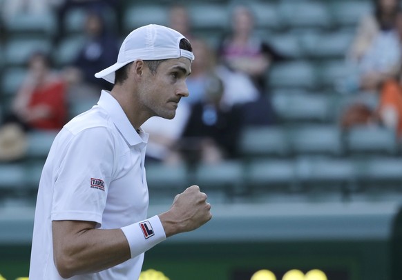 John Isner of the United States celebrates winning a point during his men&#039;s quarterfinals match against Canada&#039;s Milos Raonic, at the Wimbledon Tennis Championships, in London, Wednesday Jul ...