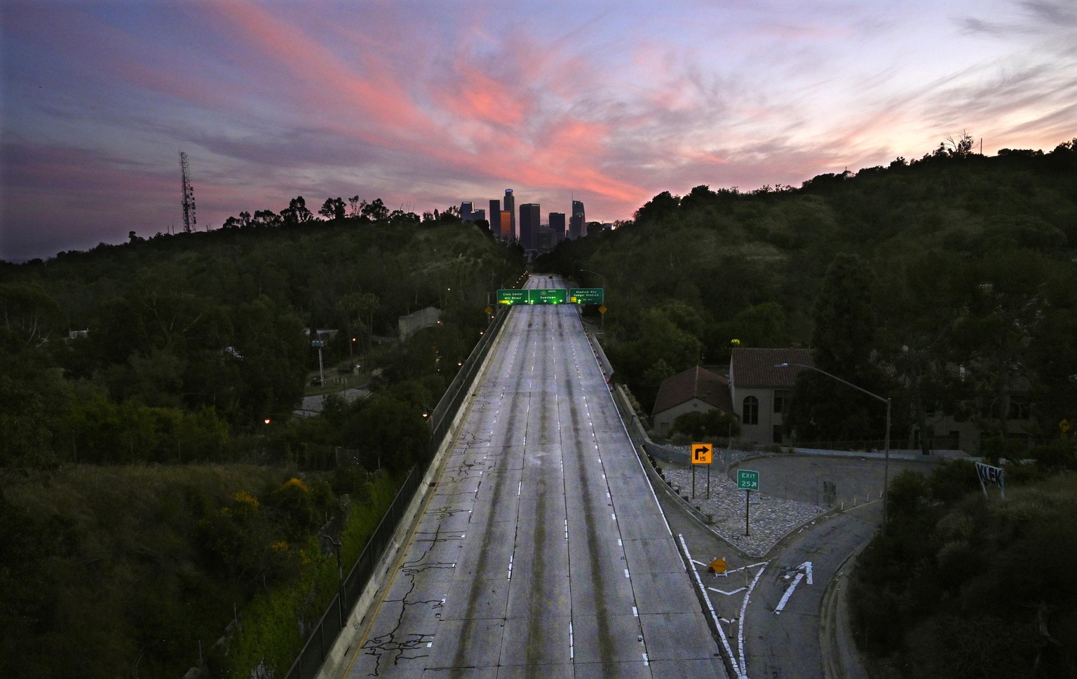 FILE - In this April 26, 2020, file photo, empty lanes of the 110 Arroyo Seco Parkway that leads to downtown Los Angeles is seen during the coronavirus outbreak in Los Angeles, Calif. The world cut it ...