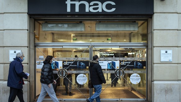 People enter a Fnac multimedia store, which remains open despite the lockdown in Paris, Friday, Oct. 30, 2020. France re-imposed a monthlong nationwide lockdown Friday aimed at slowing the spread of t ...