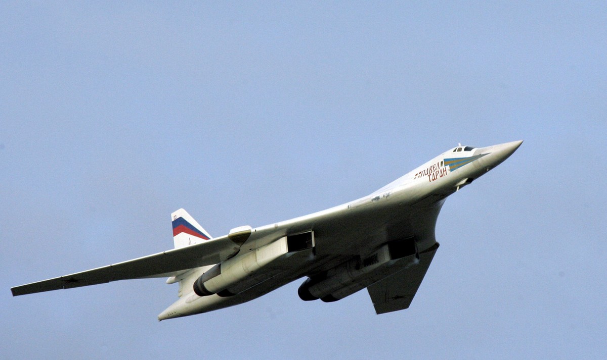 FILE - In this Aug. 16, 2005 file photo, a supersonic Tu-160 strategic bomber with Russian President Vladimir Putin aboard flies above an airfield near the northern city of Murmansk. Putin's thre ...