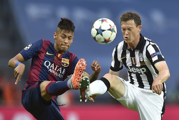 Barcelona's Neymar, left, and Juventus' Stephan Lichtsteiner challenge for the ball during the Champions League final soccer match between Juventus Turin and FC Barcelona at the Olympic stad ...