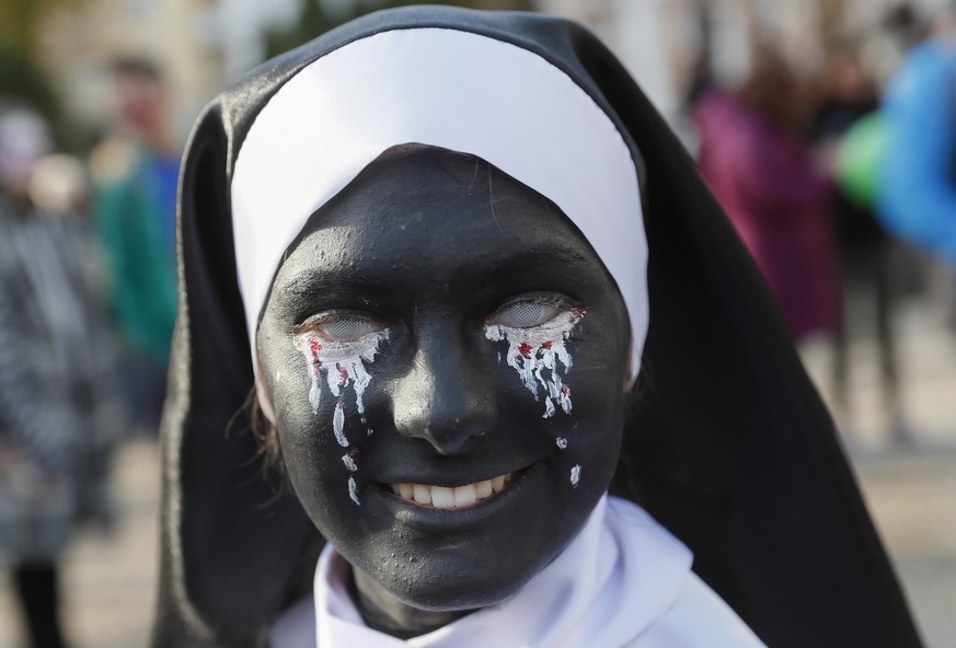 epa07124163 A young woman wearing a zombie costume and make-up attends the Zombie Walk Kiev/Halloween 2018 parade, in Kiev, Ukraine, 27 October 2018. Hundreds of people took part in the event to mark  ...