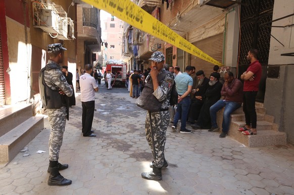 epa10120470 Soldiers stand guard at the site of the Abu Sifine church where a fire broke out in Imbaba district, Giza, Egypt, 14 August 2022. According to the ministry of health, at least 41 people we ...