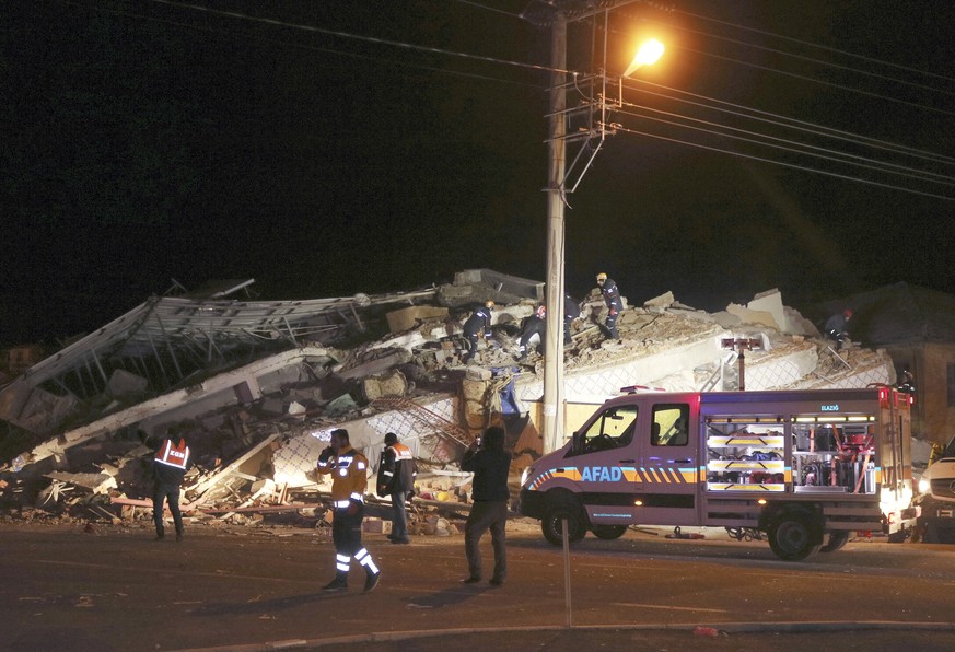 Rescue workers search on a collapsed building after a 6.8 earthquake struck Sivrice town in Elazig in eastern Turkey, Friday, Jan. 24, 2020. An earthquake with a preliminary magnitude of 6.8 rocked ea ...