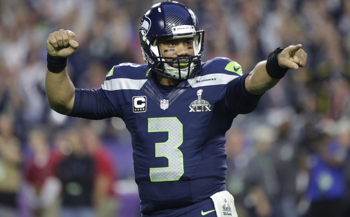 FILE - In this Feb. 1, 2015, file photo, Seattle Seahawks quarterback Russell Wilson celebrates after throwing a touchdown pass during the first half of NFL Super Bowl XLIX football game against the N ...