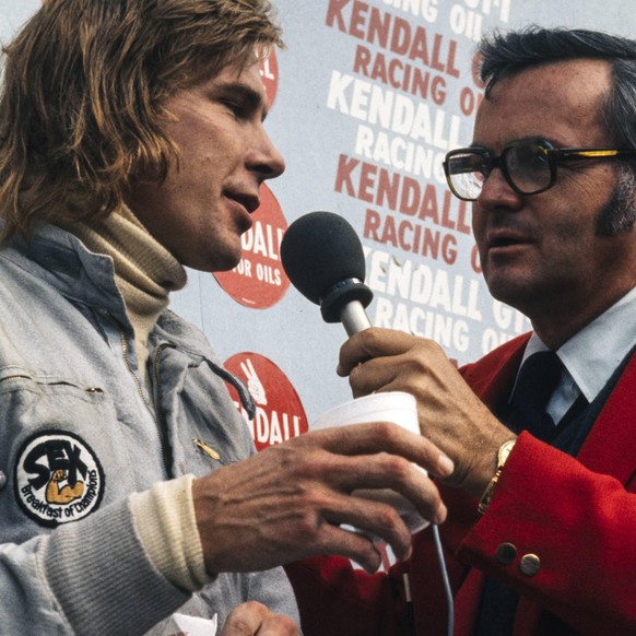 1973 United States GP WATKINS GLEN INTERNATIONAL, UNITED STATES OF AMERICA - OCTOBER 07: James Hunt, 2nd position, is interviewed on the podium during the United States GP at Watkins Glen Internationa ...