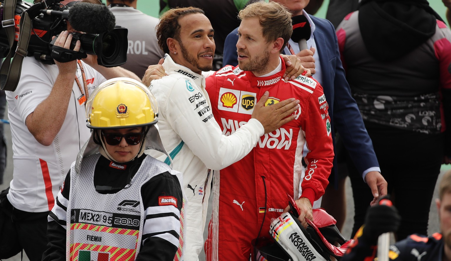 epa07127989 British driver Lewis Hamilton (C-L), of Mercedes, talks to German Sebastian Vettel, of Ferrari, after the Formula One Grand Prix, at the Hermanos Rodriguez racetrack in Mexico City, Mexico ...