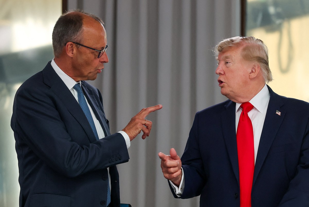 President Donald Trump speaks with Germany's Chancellor Friedrich Merz at a working lunch with leaders of G7 and the Middle East in Evian-les-Bains, France, Tuesday, June 16, 2026. (Christian Har ...