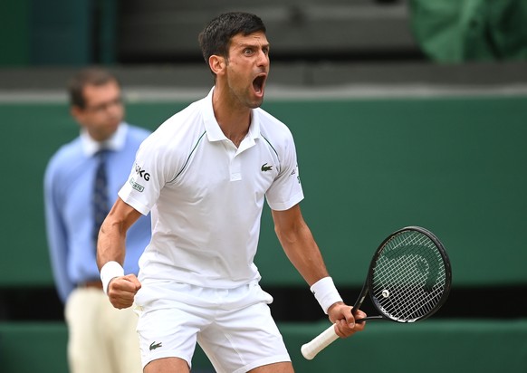 epa09334497 Novak Djokovic of Serbia reacts during his men&#039;s semi final match against Denis Shapovalov of Canada at the Wimbledon Championships in Wimbledon, Britain, 09 July 2021. EPA/NEIL HALL  ...