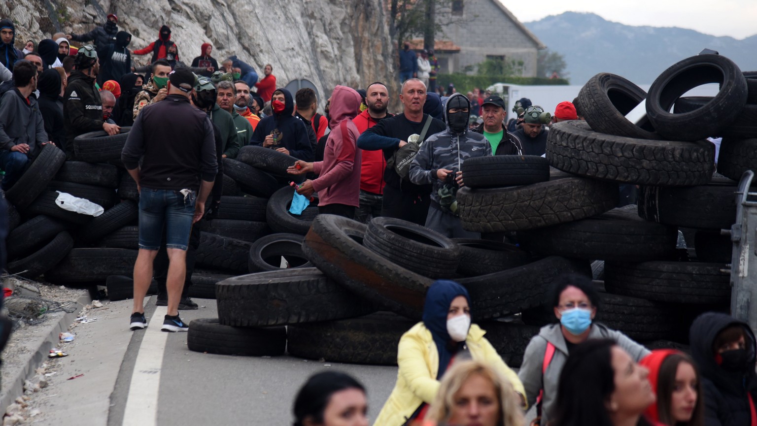 epa09448741 Demonstrators stand at a barricade during a protest against the enthronement of the Serbian Orthodox bishop in Cetinje, Montenegro, 05 September 2021. The enthronement of the new bishop of ...