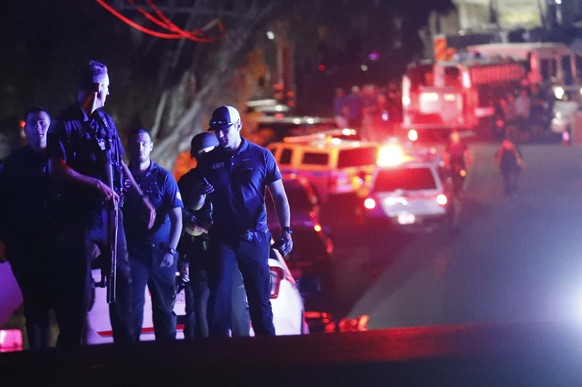 epa07747037 Law enforcement officers near the entrance of Christmas Hill Park, where the Gilroy Garlic Festival was coming to an end of the last day where an active gunman fired upon patrons killing t ...