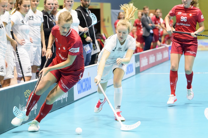 Switzerland&#039;s Mirjam Hintermann, left, vies for the ball with Germany&#039;s Theresa Beppler-Alt, right, during the 12th Women&#039;s World Floorball Championships Group A qualification game betw ...