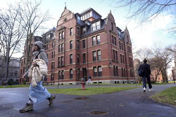 FILE - People walk between buildings, Dec. 17, 2024, on the campus of Harvard University in Cambridge, Mass. (AP Photo/Steven Senne, File)
Education Trump Harvard