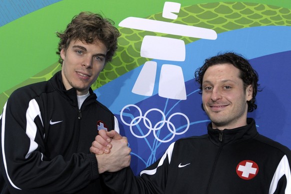 Swiss New York Islanders hockey player Mark Streit, right, and Swiss Anaheim Ducks goalie Jonas Hiller, left, cheer after a press conference after a training session of the Swiss ice hockey men team i ...