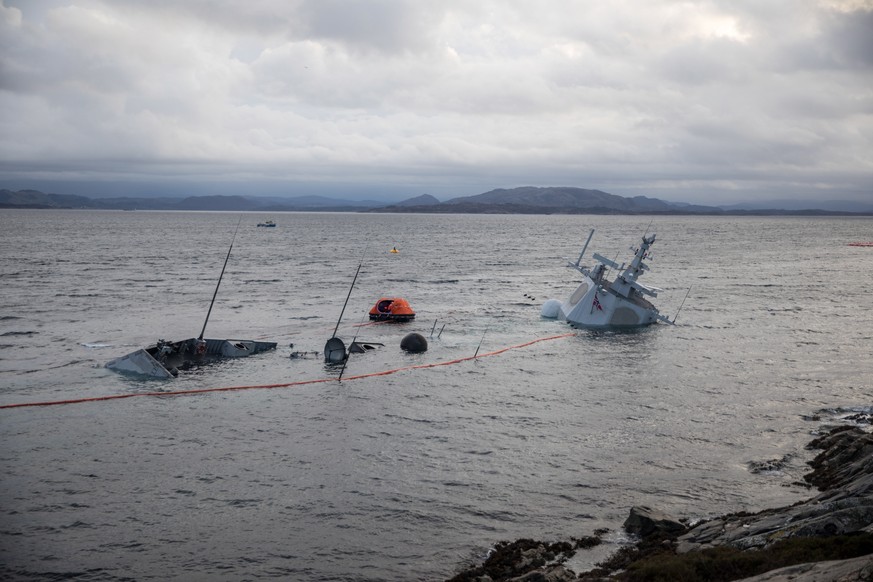 epa07162534 A handout photo made available by the Norwegian Armed Forces shows the Norwegian frigate KNM Helge Ingstad partly under water in the sea near Bergen, western Norway, 13 November 2018. The  ...