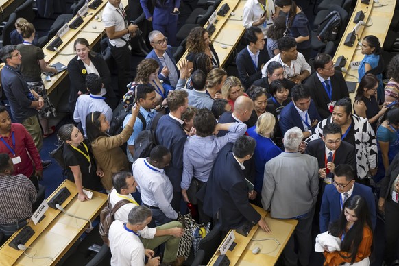 Delegates reacts during a plenary session of Second Part of the Fifth Session of the Intergovernmental Negotiating Committee on Plastic Pollution (INC-5.2), at the European headquarters of the United  ...