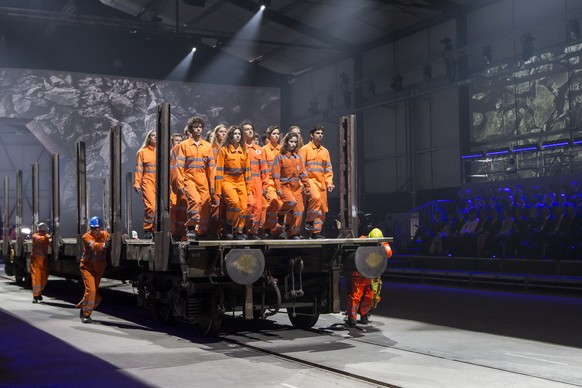 Artists perform during the opening show directed by German director Volker Hesse, on the opening day of the Gotthard rail tunnel, the longest tunnel in the world, at the fairground Rynaecht at the nor ...