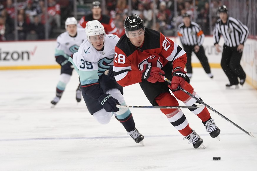 Seattle Kraken&#039;s Ryker Evans, left, chases New Jersey Devils&#039; Timo Meier during the second period of an NHL hockey game in Newark, N.J., Monday, Feb. 12, 2024. (AP Photo/Seth Wenig)
Ryker Ev ...