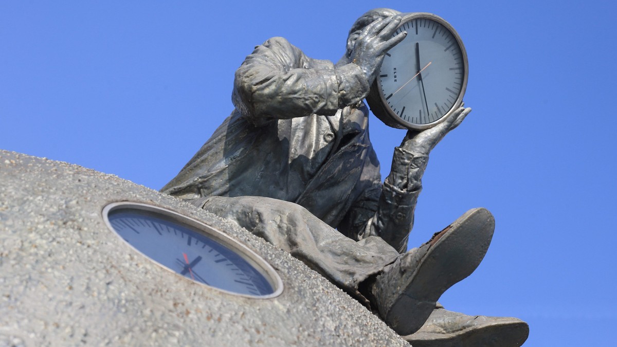 epa04678152 View of the 'time meter' by Gloria Friedmann near the river Elbe in Magdeburg, Germany, 25 March 2015. The artwork depicts a man holding a clock and sitting atop a three-meter ta ...