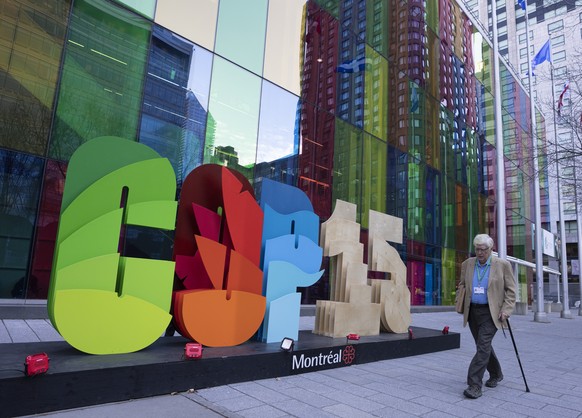 A delegate walks past the convention center at the COP15 biodiversity conference Wednesday, Dec. 14, 2022 in Montreal. (Ryan Remiorz/The Canadian Press via AP)