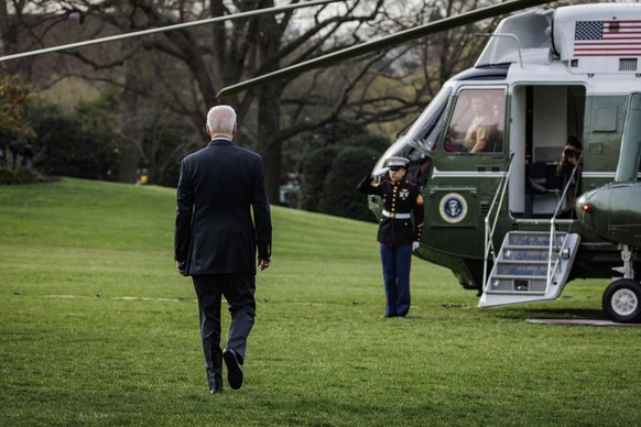 epa09844205 US President Joe Biden walks on the South Lawn of the White House before boarding Marine One in Washington, DC, USA, 23 March 2022. Biden and allies meeting on 24 March in Brussels are exp ...