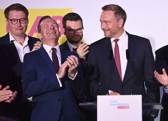 Christian Lindner, right, FDP party leader, and the Liberal party leadership stand on stage at the FDP election party fter the first forecasts were announced, in Berlin, Sunday, Sept. 26, 2021. Next t ...