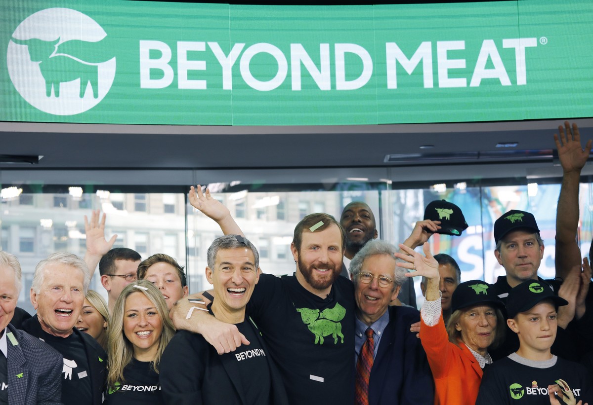 FILE - In this May 2, 2019, file photo Ethan Brown, center, CEO of Beyond Meat, attends the Opening Bell ceremony with guests to celebrate the company's IPO at Nasdaq in New York. Plant-based mea ...