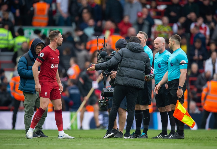 epa10566493 Liverpool&#039;s Jordan Henderson (L) reacts with the officials at half time during the English Premier League soccer match between Liverpool and Arsenal at Anfield in Liverpool, Britain,  ...
