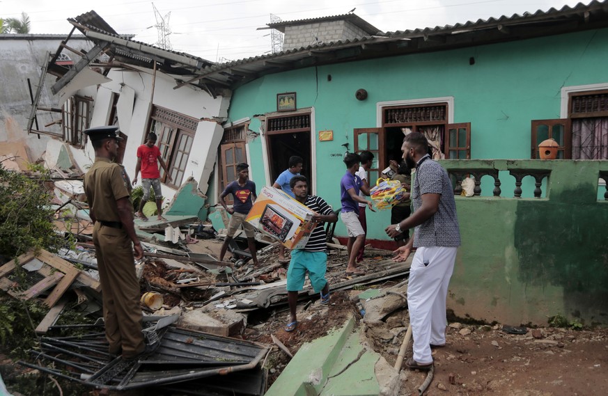 Sri Lankan army soldiers and rescue workers salvage belongings of residents of the line of buried houses in a collapse of a garbage dump in Meetotamulla, on the outskirts of Colombo, Sri Lanka, Saturd ...