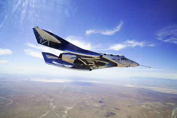 This May 29, 2018 photo, courtesy of Virgin Galactic, shows the company's VSS Unity on its second supersonic flight.  After reaching nearly 50,000 feet (15,000 meters), Unity will be released…