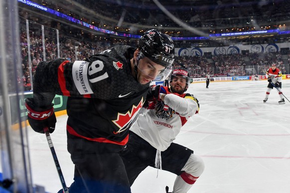 PRAGUE, CZECH REPUBLIC - MAY 14: John Tavares of Canada protects the puck along the boards during the preliminary round match between Canada and Austria at Prague Arena on May 14, 2024 in Prague, Czec ...