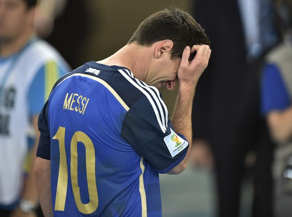 FILE - In this July 13, 2014, file photo, Argentina's Lionel Messi scratches his head as he goes up to get his runners-up medal after the World Cup final soccer match between Germany and Argentin ...