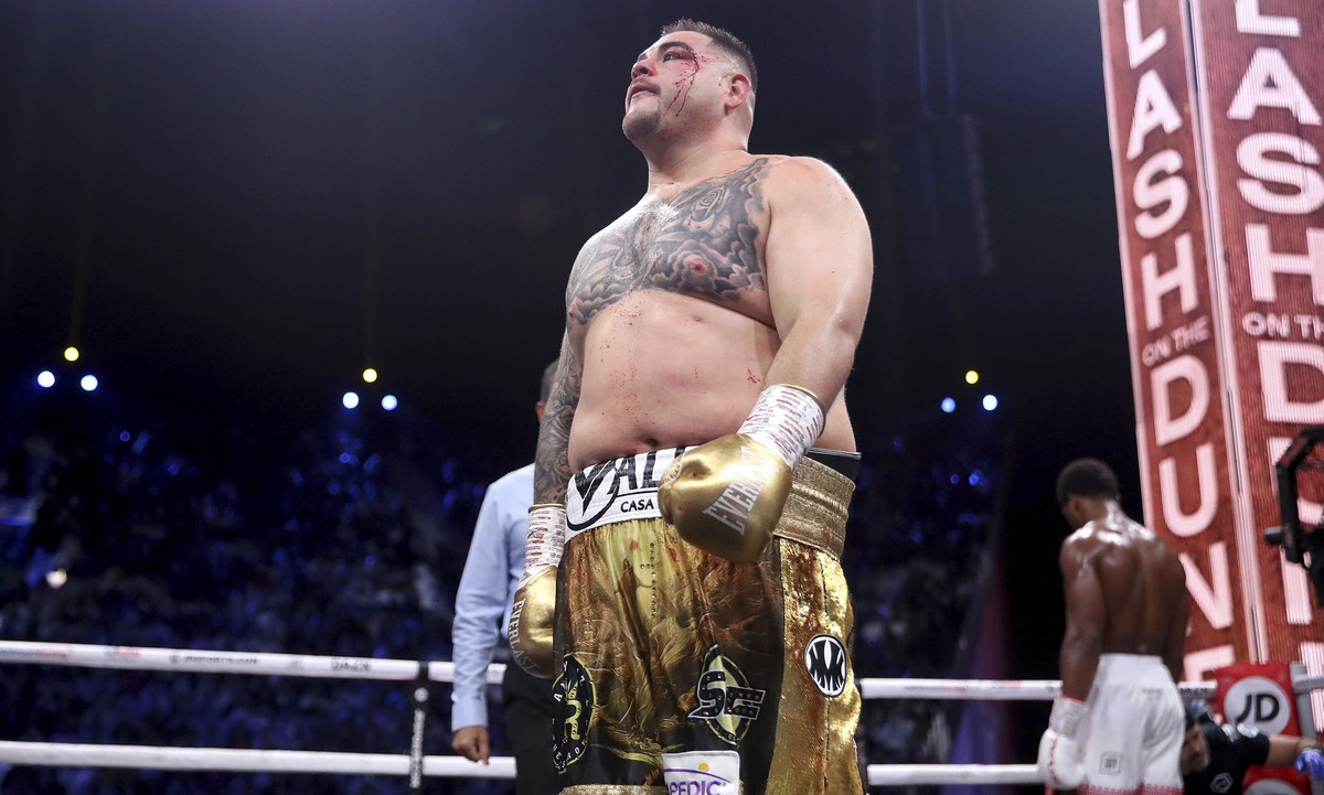 Defending champion Andy Ruiz Jr., left, walks back to his corner at the end of a round after getting cut during his fight against Britain's Anthony Joshua in their World Heavyweight Championship  ...